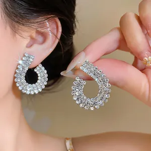Close-up of elegant rhinestone-encrusted geometric earrings with shimmering detail