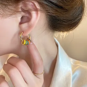 Detailed view of gold plated hoop earrings featuring vibrant colorful enamel beads