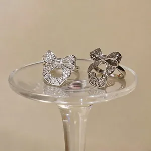 Elegant silver bow-shaped open ring with a hollow design and sparkling details for women