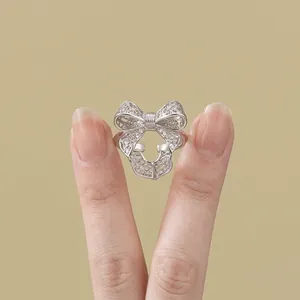 Elegant silver bow hollow open ring with adjustable band and sparkling texture for women