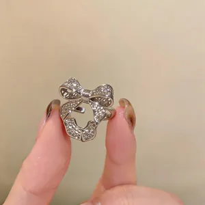 Close-up macro view of an elegant silver hollow-out bow-shaped open adjustable ring
