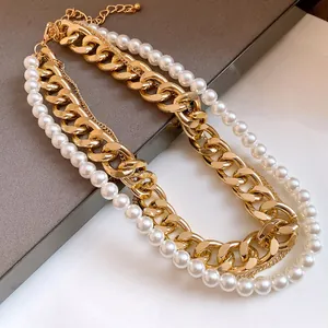 Close-up detail of a layered gold chain and white pearl necklace for vintage fashion style.