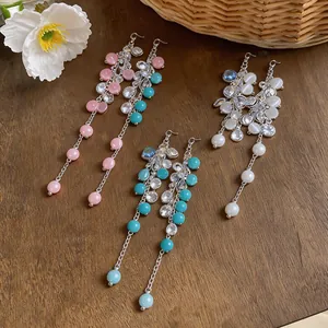 Elegant long tassel earrings with shimmering zircons and colorful cat-eye beads.