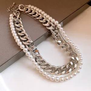 Detailed view of an elegant multi-layer necklace with silver chains and white pearls.
