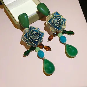 Vintage style green rose dangle earrings with gold leaf accents and emerald teardrop beads