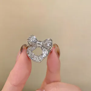 Detailed macro view of an elegant hollow bow-knot open ring with sparkling silver finish