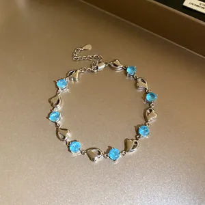 Detail shot of silver heart bracelet featuring brilliant sky blue round zircon stones