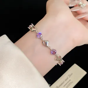 Elegant silver bracelet with purple zircon stones and heart motifs shown on a wrist
