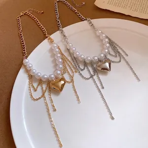 Elegant pearl beaded heart pendant necklace with layered gold and silver chain tassels