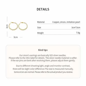 Details of 14k gold plated hoop earrings with pearls and zircons on white background
