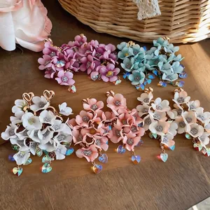 Elegant handmade fabric flower tassel earrings with iridescent heart crystals