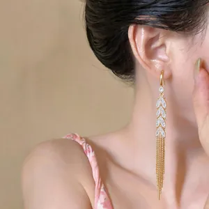Elegant 18k gold-plated tassel earrings with zircon wheat ear design shown on model