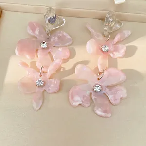 Handmade pink resin flower earrings with clear heart-shaped studs and rhinestones