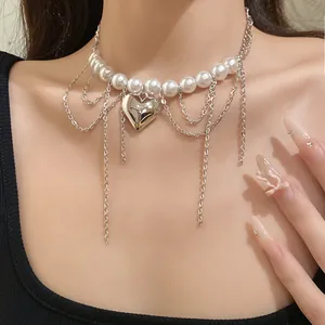 Elegant vintage pearl choker necklace with layered chains and a silver heart pendant