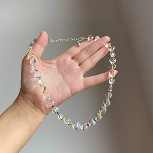 Close-up view of a clear ice heart beaded necklace with vibrant rainbow colored spacers