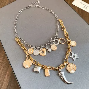 Close-up of vintage double-layered necklace with gold and silver heart charms
