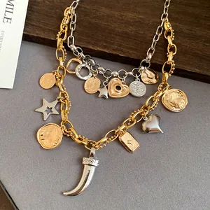 Detail view of a vintage double-layer necklace with gold and silver charms and heart pendant.