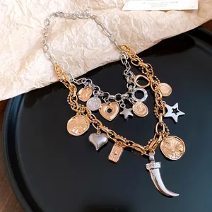 Detailed macro view of a vintage double-layered necklace featuring heart and coin charms