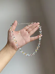 Close-up of clear heart beads and colorful spacers on a summer choker necklace