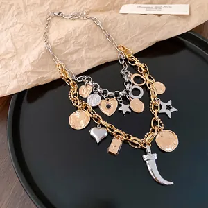 Detailed view of layered mixed-metal necklace with vintage coins and heart charms
