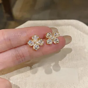 Close-up of 18K gold plated flower ear clips with sparkling zircon stones