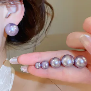 Macro detail of purple pearl earrings in various sizes with elegant 18K gold plating finish