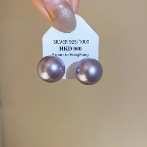 Detail of purple pearl stud earrings on a silver 925 card holder display