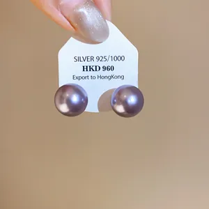 Close-up view of elegant purple pearl stud earrings mounted on a 925 silver display card.