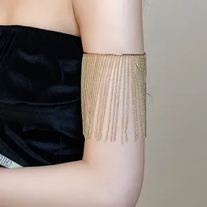 Elegant gold tassel arm cuff bracelet shown on model's upper arm with metal chains