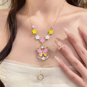 Close-up detail of a colorful butterfly and flower rhinestone necklace worn by a model