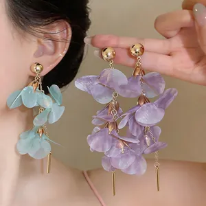 Detailed macro view showing the delicate purple and mint green translucent petal drop earrings.
