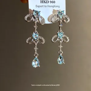 Elegant light blue heart and teardrop crystal tassel earrings with a refined silver finish
