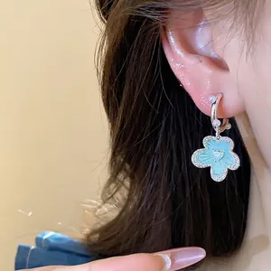 Blue enamel flower earrings with pearls and zircons on silver needles for women.