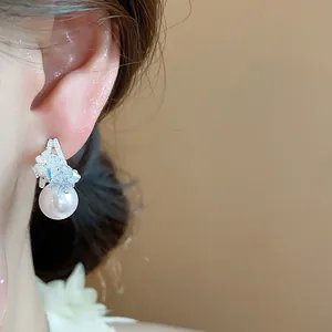 Primo piano di un elegante orecchino di perla a forma di C con cristalli