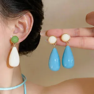 Detailed view of elegant teardrop resin earrings with smooth texture and vibrant colors