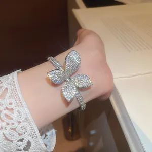 Macro view of sparkling zircon butterfly bangle showing brilliant gemstone fire and setting