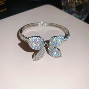 Close-up of a sparkling silver butterfly bangle with pavé cubic zirconia details.