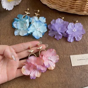 Elegant fabric flower drop earrings with golden bird motif in multiple pastel colors