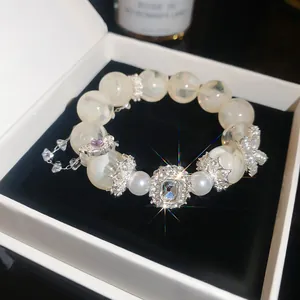 Detailed macro view of sparkling zircon flower bracelet in white jewelry gift box