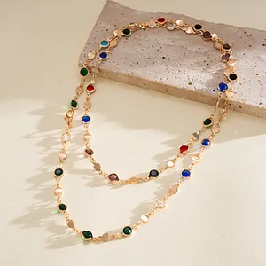 Detailed shot of a multi-color crystal necklace with gold geometric round discs