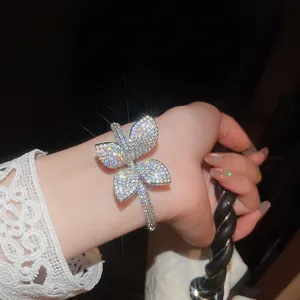 Close-up of a luxurious silver flower bracelet with sparkling zircons worn on a wrist