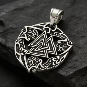 Detailed macro view of a vintage steel Viking Valknut pendant on a dark stone background