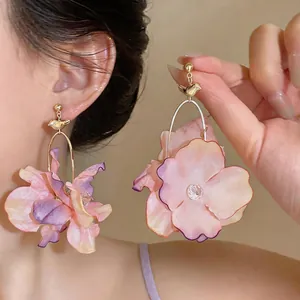 Elegant handmade fabric flower drop earrings with a golden bird motif for a sweet look.