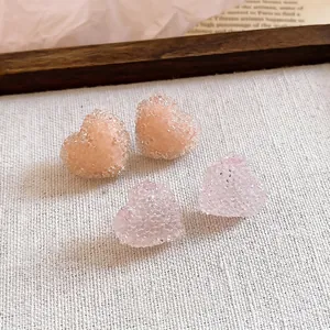 Korean style resin jelly heart stud earrings with crushed ice texture on canvas background