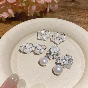 Exquisite floral pearl earrings set featuring delicate rhinestone accents in warm scene