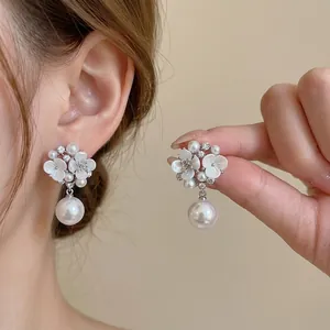 Elegant floral pearl drop earrings with sparkling CZ accents and silver needles for women