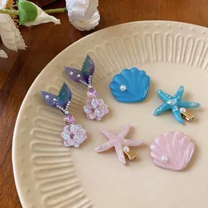 Summer vacation marine theme hair clip set featuring starfish and shells on duckbill clips