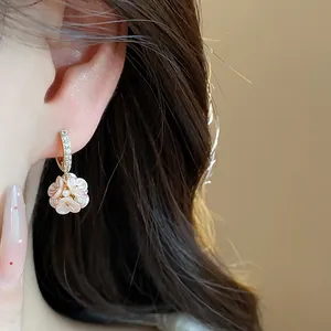 Detailed close-up showing French style floral drop earrings with zircons and pearls on ear