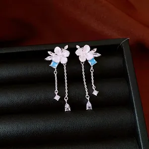 Elegant silver flower tassel earrings with blue zircon and white petals on black box