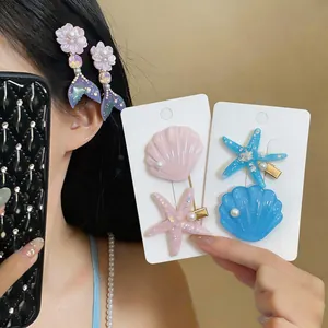 Exquisite seashell and starfish hair clips with pearl detail for beach vacation styles.
